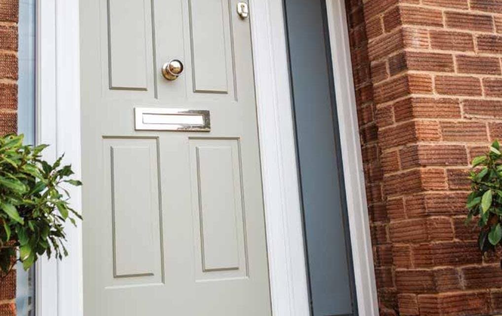 Comp Door cream composite entrance door in a Victorian arched brick porch