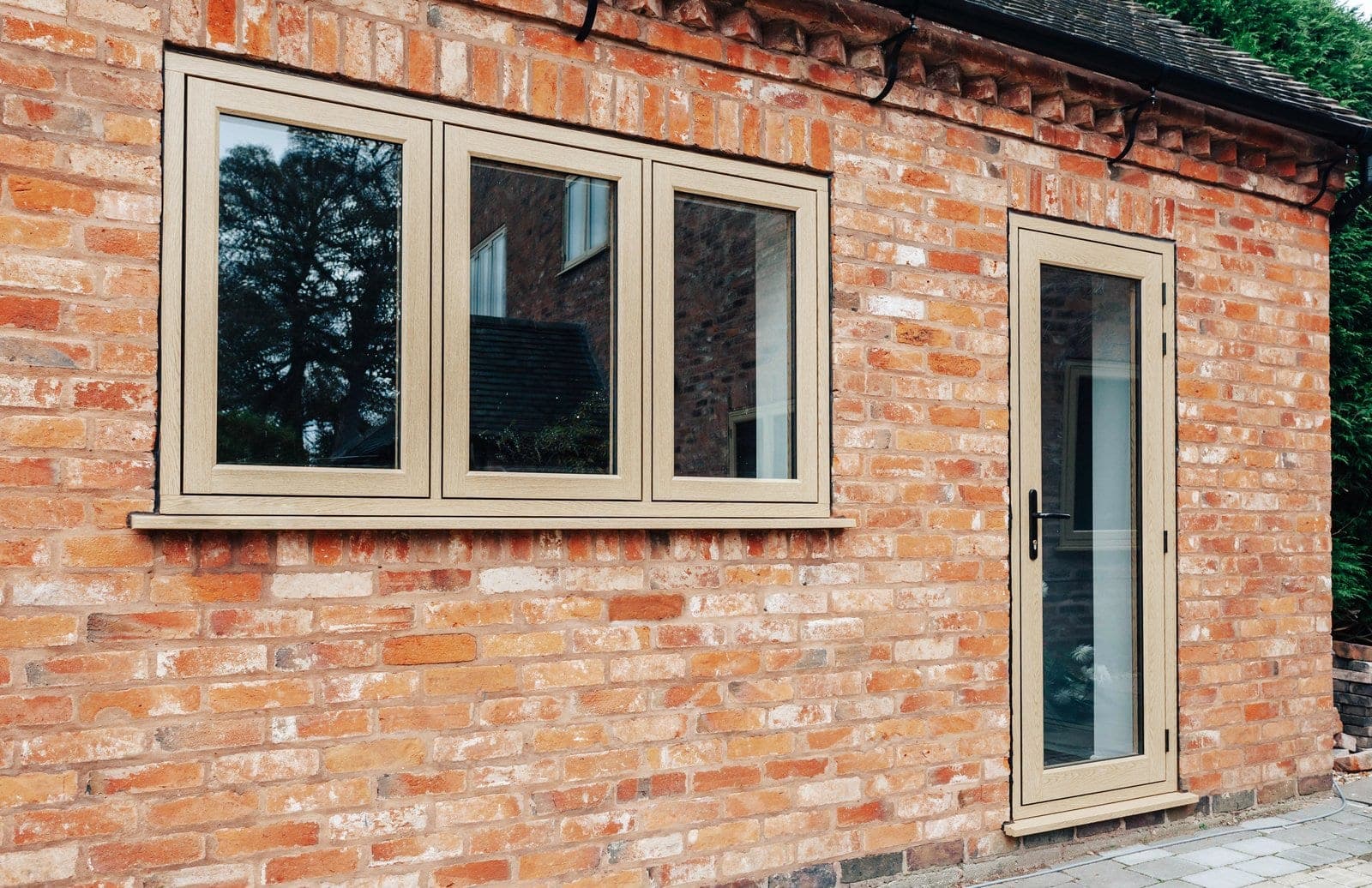 The Residence Collection R9 windows in oak woodgrain on a period brick property