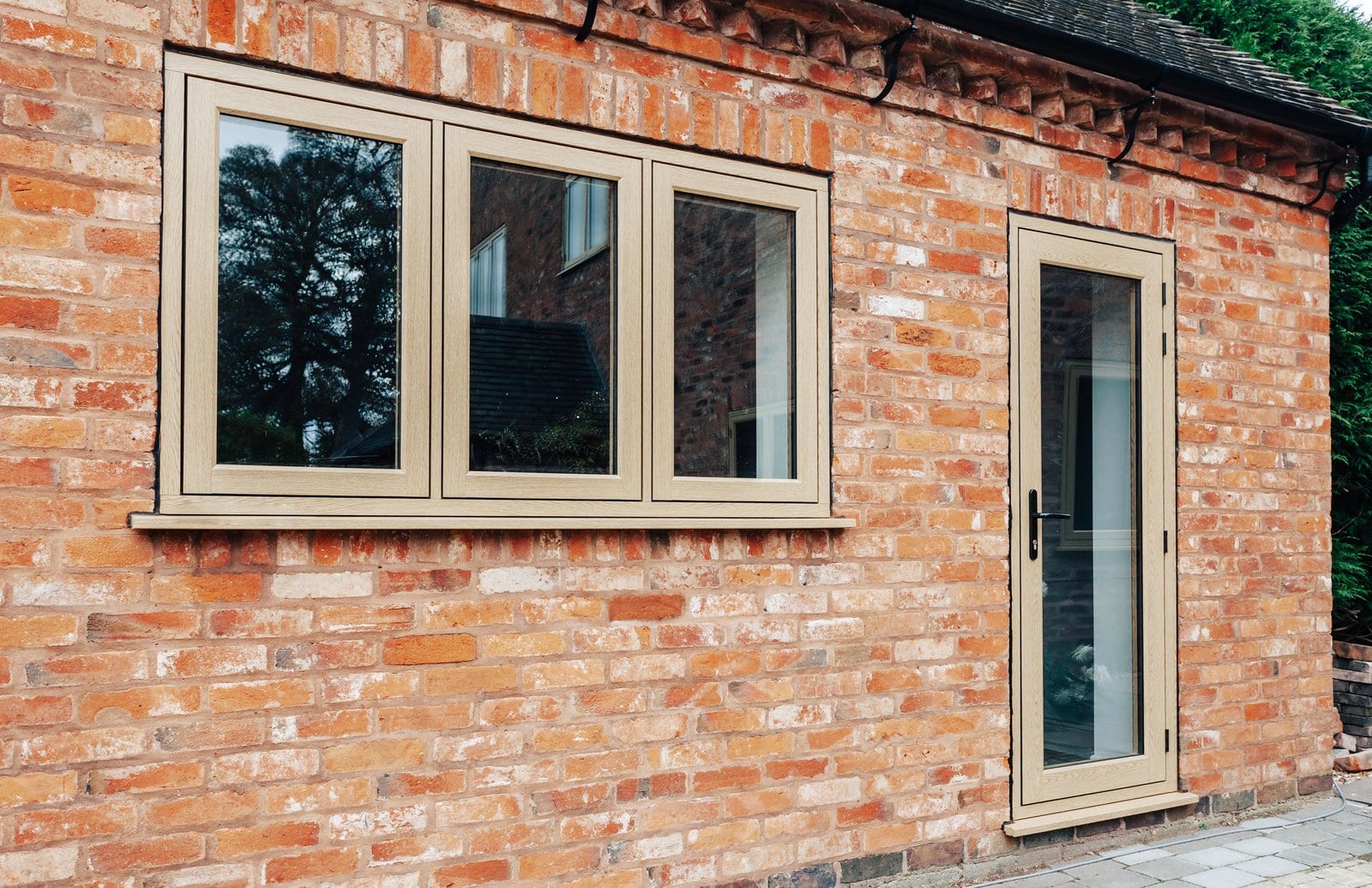 The Residence Collection R9 windows in oak woodgrain on a period brick property