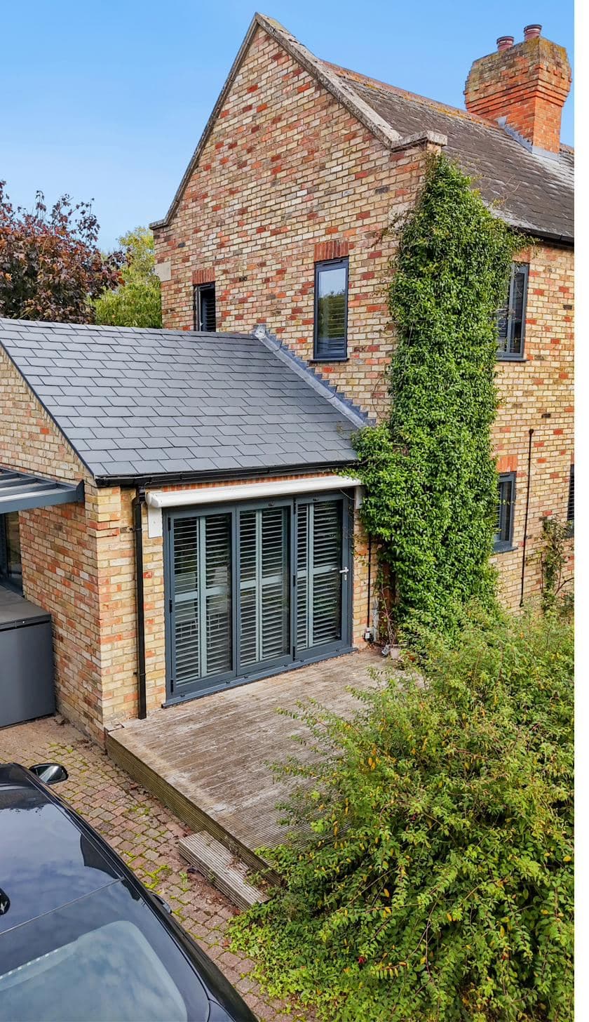 Schüco-quality aluminium bifold doors on a slate-roof rear extension