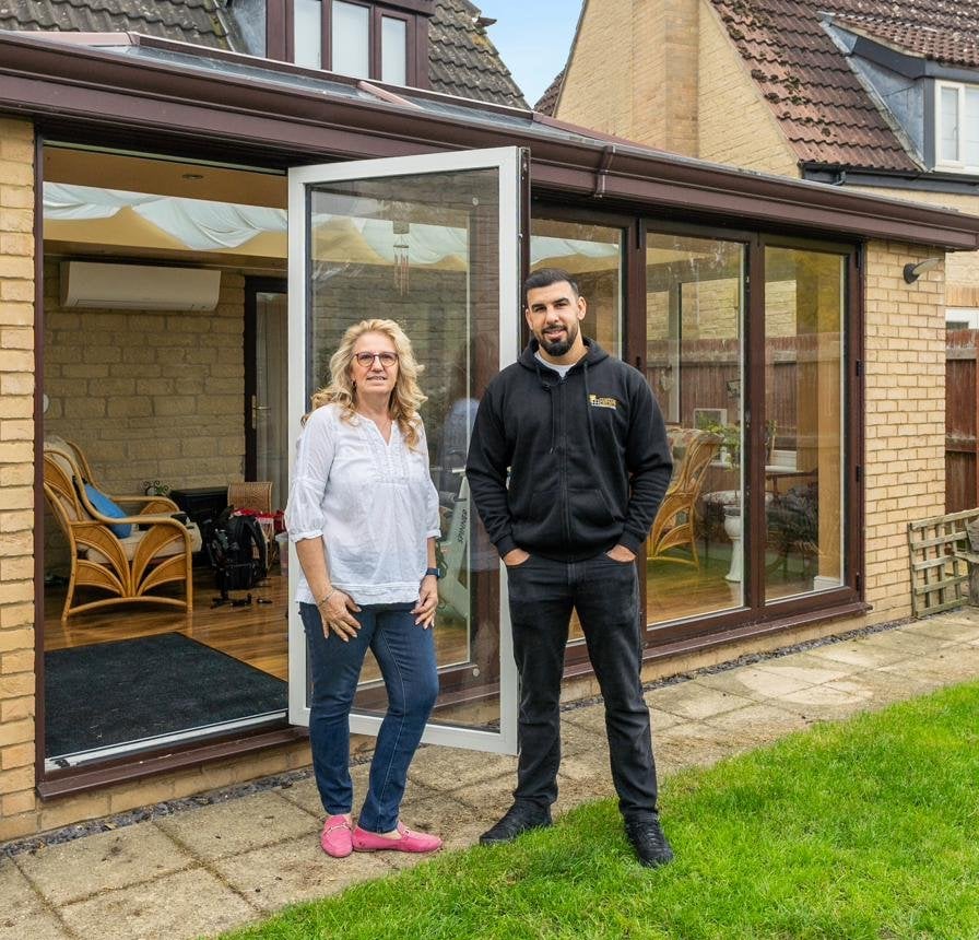 Tariq Quaddus of Custom Choice with a Peterborough homeowner at the handover of her new conservatory and bifold installation