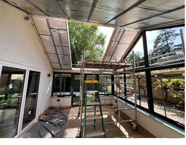Custom Choice installation in progress — aluminium frames fitted and the roof structure going in