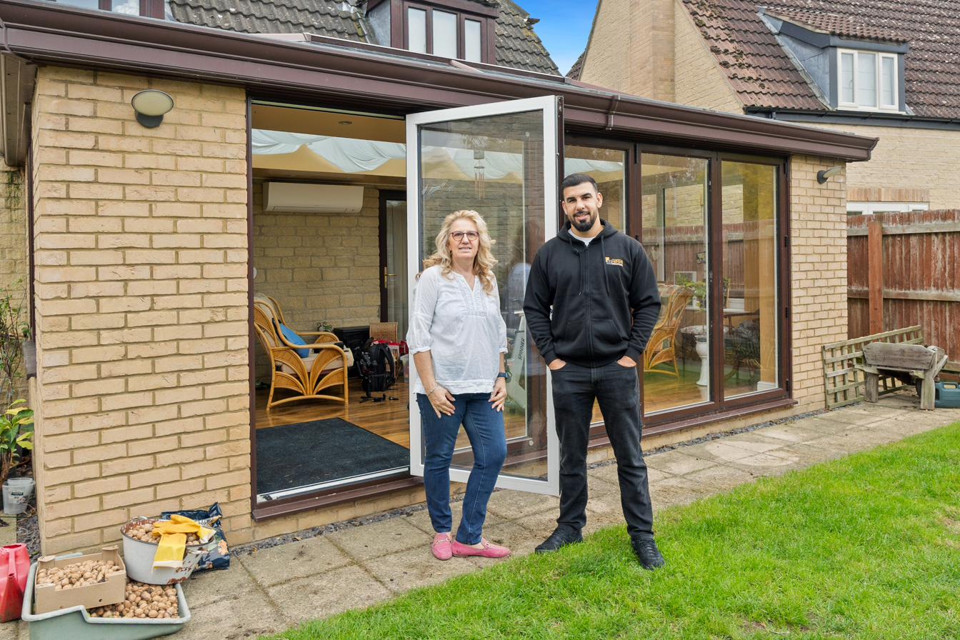 Tariq Quaddus with a homeowner at the handover of her Origin door installation in Peterborough