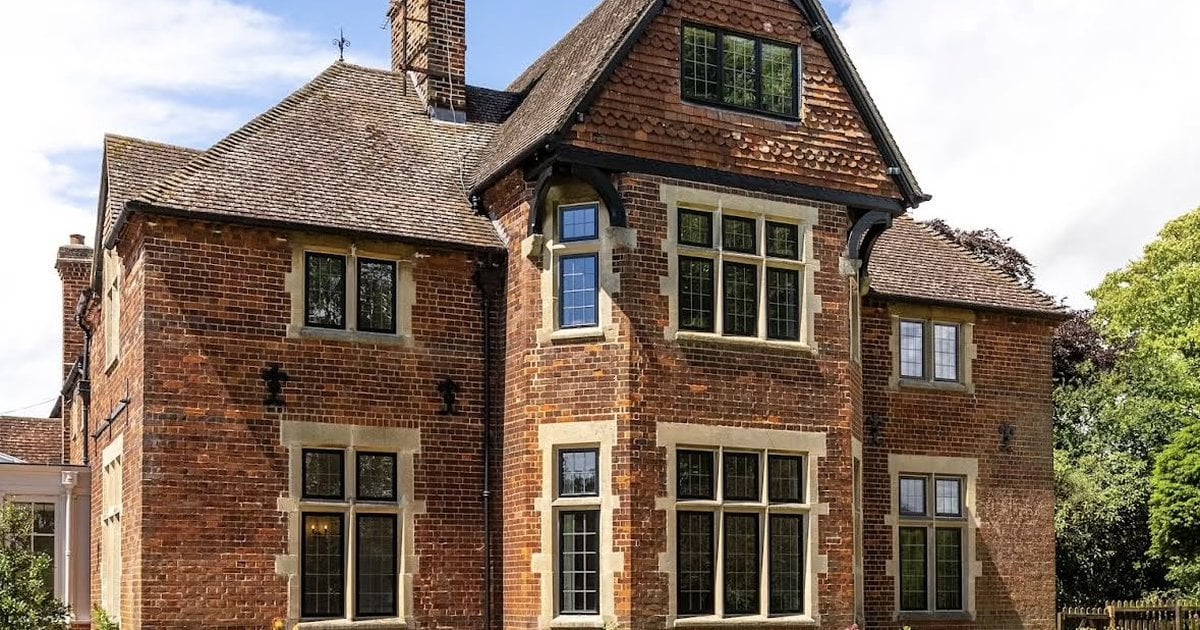 Period red-brick home with black heritage windows and leaded glazing, fitted by Custom Choice