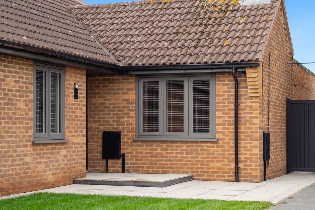 Warm, A-rated anthracite uPVC casement windows fitted on a Peterborough bungalow by Custom Choice