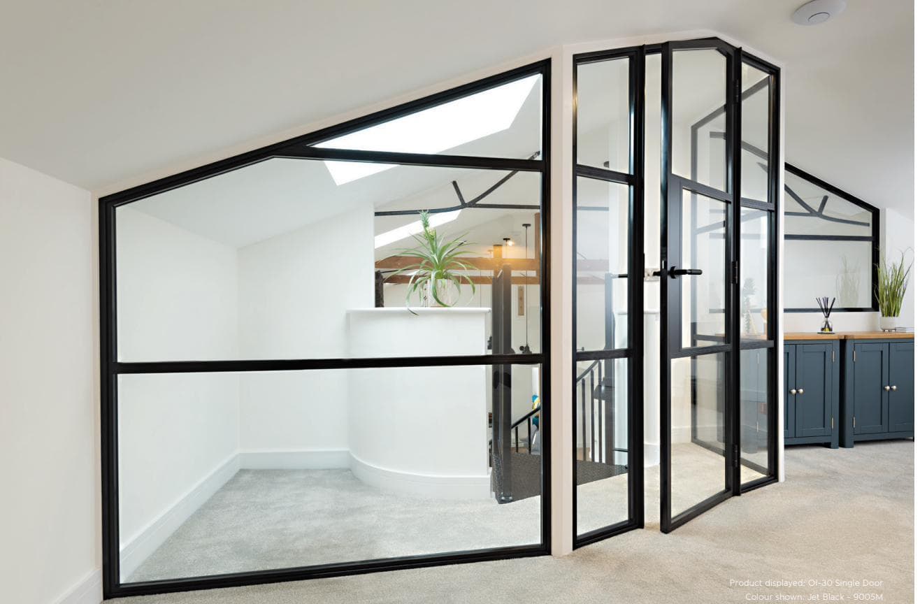 Internal Crittall-style glazed doors in jet black aluminium dividing a bright open-plan home