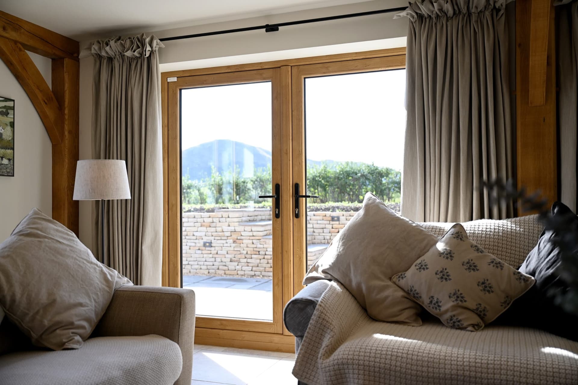 Oak-effect Cortizo French doors with a warm interior, opening to garden